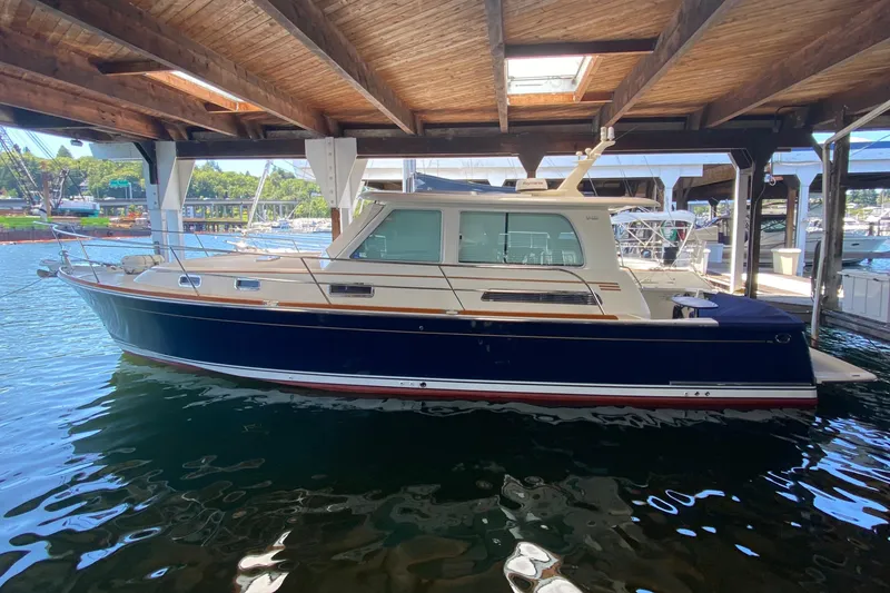 Slide: The Image of 2011 Sabre 42 Salon Express yacht docked under wooden canopy. - 1