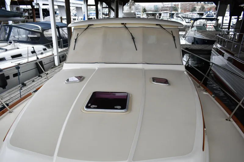 Slide: The Image of 2011 Sabre 42 Salon Express yacht docked, showcasing its sleek deck design. - 12