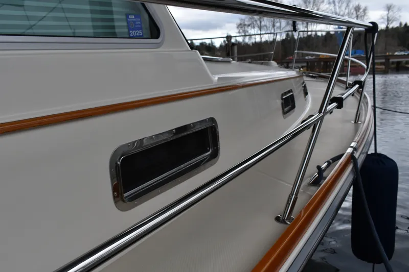 Slide: The Image of 2011 Sabre 42 Salon Express yacht side view with sleek railings and window details. - 14