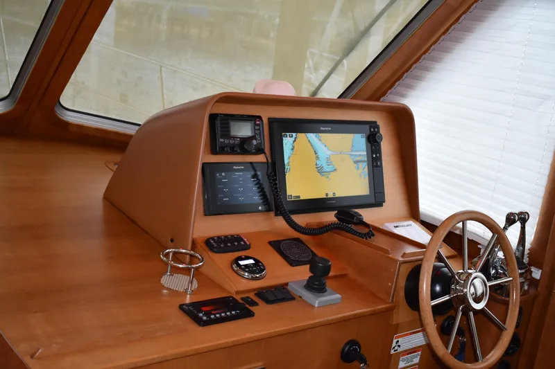 Slide: The Image of 2011 Sabre 42 Salon Express helm with navigation equipment and wooden steering wheel. - 18