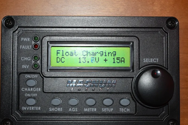 Slide: The Image of Magnum Energy control panel displaying float charging at 13.7V and 15A. - 22
