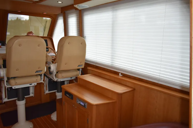 Slide: The Image of 2011 Sabre 42 Salon Express interior with beige captain chairs and cherry wood paneling and joinery - 24