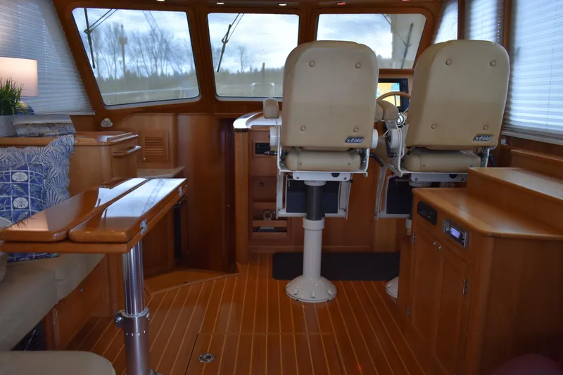 Slide: The Image of 2011 Sabre 42 Salon Express interior with helm chairs and teak and holly flooring. - 25