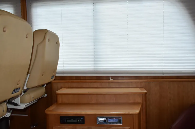 Slide: The Image of Interior of 2011 Sabre 42 Salon Express with beige seats and wooden paneling. - 28
