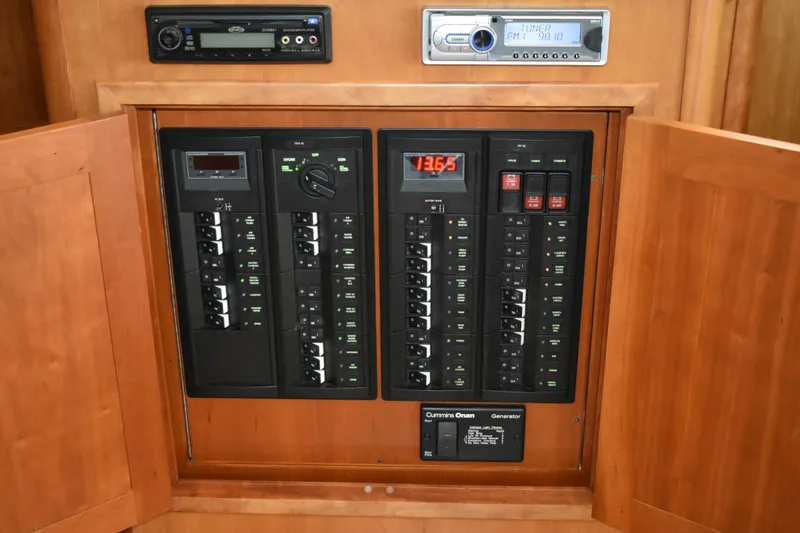 Slide: The Image of Electrical panel inside 2011 Sabre 42 Salon Express yacht, featuring control switches and stereo system. - 29
