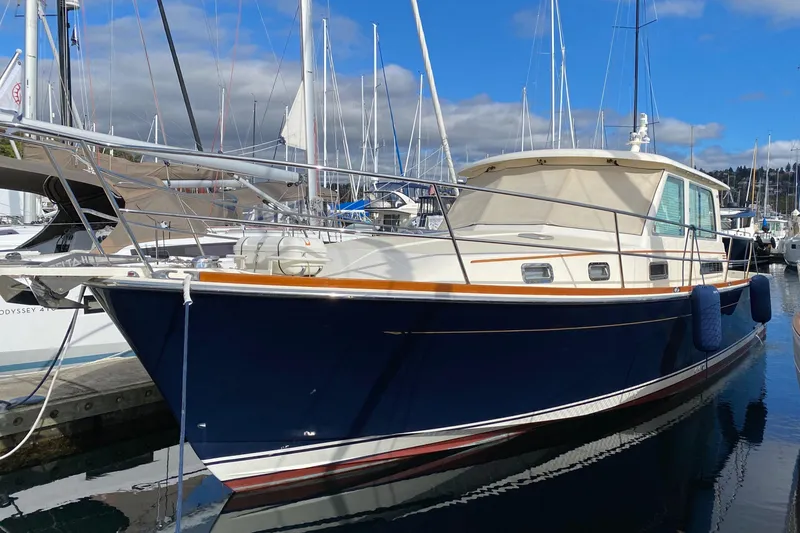 Slide: The Image of 2011 Sabre 42 Salon Express yacht docked in marina, blue hull, sunny day. - 3