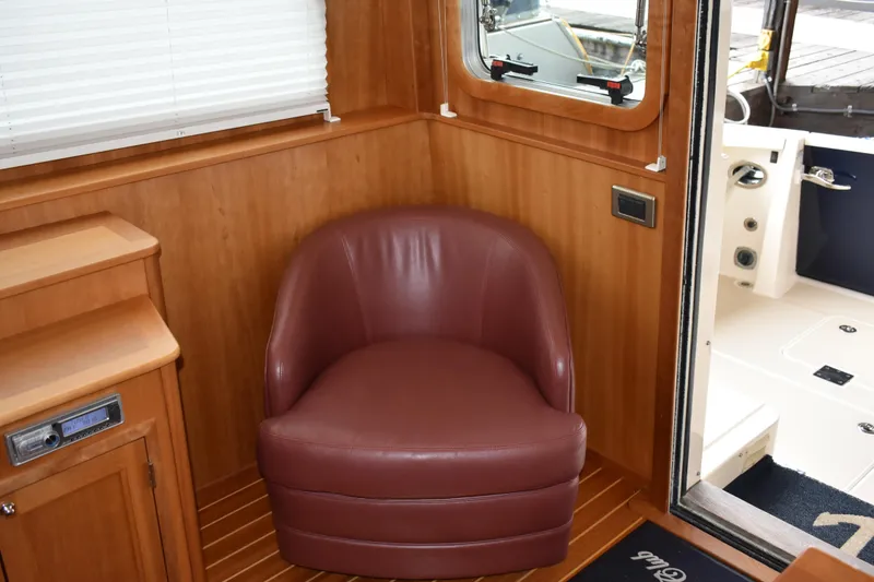 Slide: The Image of Luxurious interior of 2011 Sabre 42 Salon Express with tub chair and wooden paneling. - 31