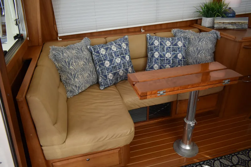 Slide: The Image of Interior of 2011 Sabre 42 Salon Express with cushioned seating and decorative pillows. - 34