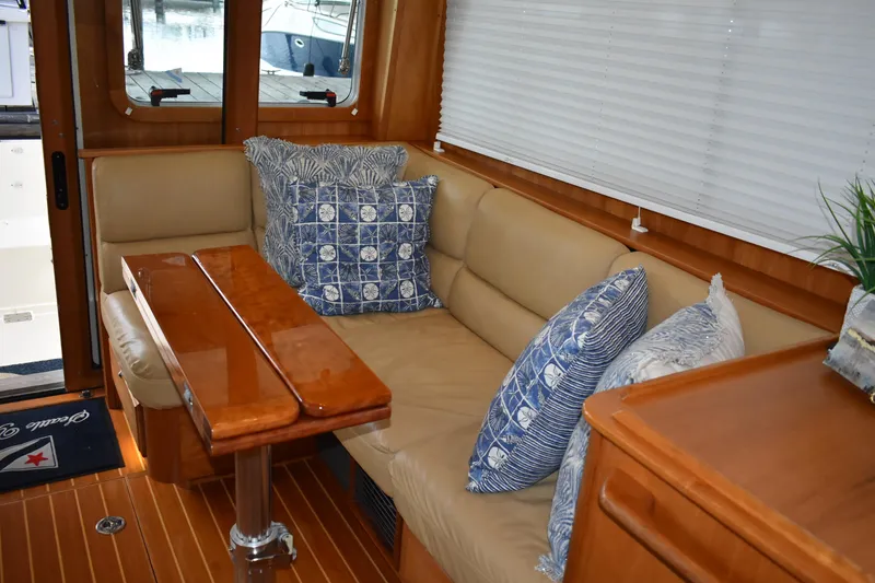 Slide: The Image of Interior of 2011 Sabre 42 Salon Express with cozy seating and decorative pillows. - 36