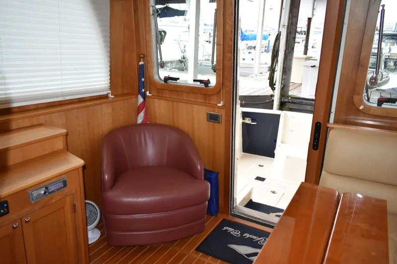 Slide: The Image of 2011 Sabre 42 Salon Express interior with tub chair and wooden accents. - 37
