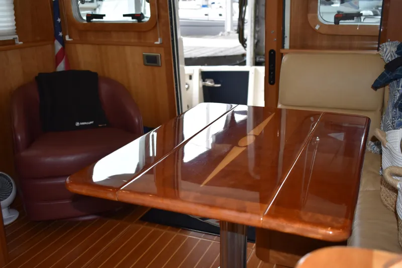 Slide: The Image of Interior of 2011 Sabre 42 Salon Express with polished wooden table and seating. - 39