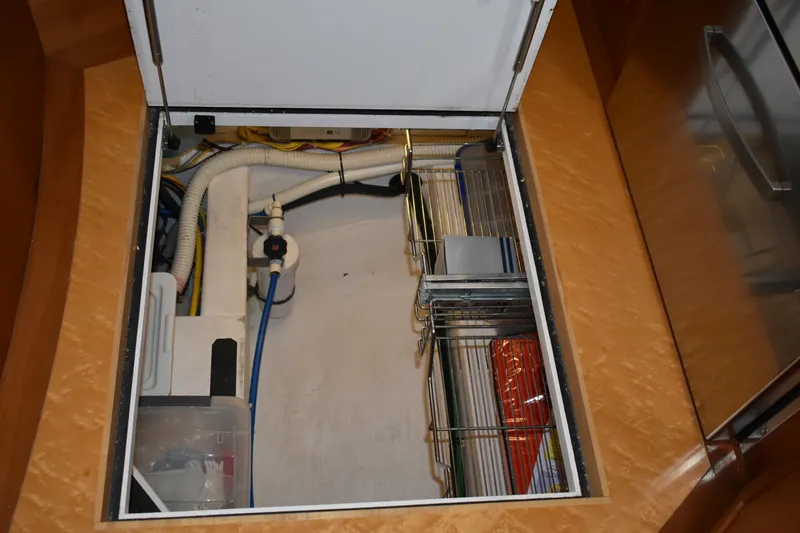 Slide: The Image of 2011 Sabre 42 Salon Express storage compartment with organized wiring and plumbing. - 43