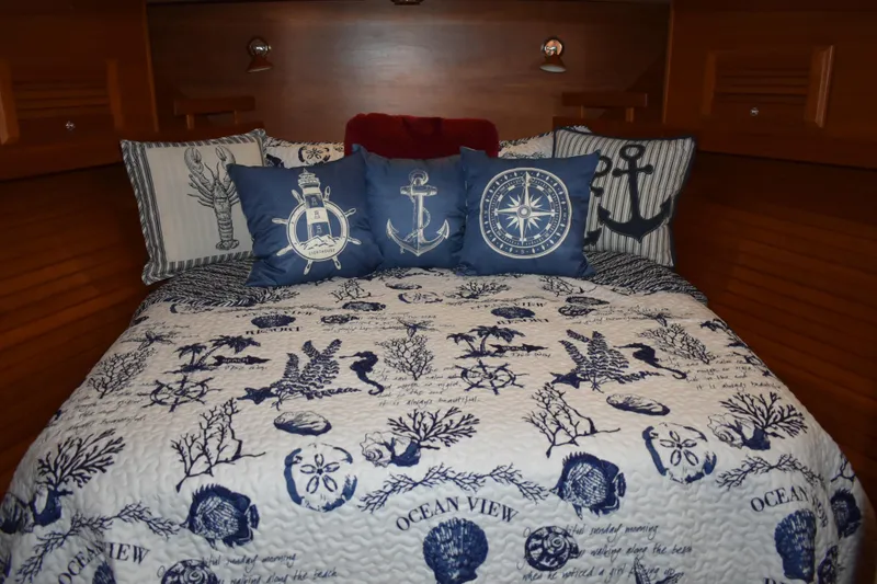 Slide: The Image of Nautical-themed bedding in 2011 Sabre 42 Salon Express cabin, featuring anchor and compass designs. - 45