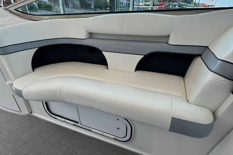 Slide: The Image of 2020 Formula 370 SS boat interior seating with white and gray upholstery. - 10