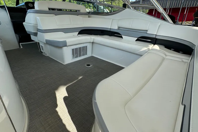 Slide: The Image of 2020 Formula 370 SS boat interior with spacious white seating and carpeted flooring. - 11