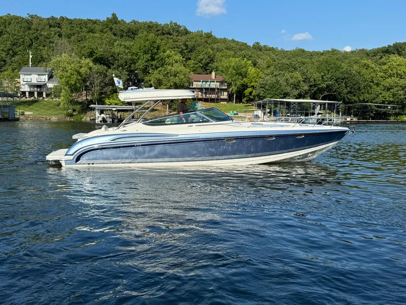 Slide: The Image of 2020 Formula 370 SS boat on a serene lake with lush green shoreline. - 2