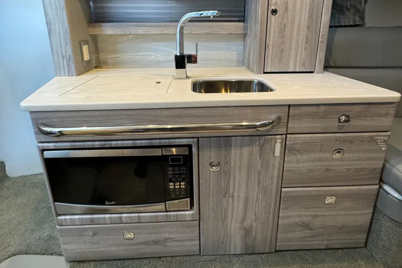 Slide: The Image of Modern kitchenette in a 2020 Formula 370 SS boat with sink and microwave. - 25
