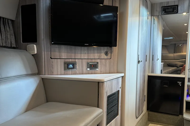 Slide: The Image of Interior of 2020 Formula 370 SS boat with TV, seating, and modern cabinetry. - 31