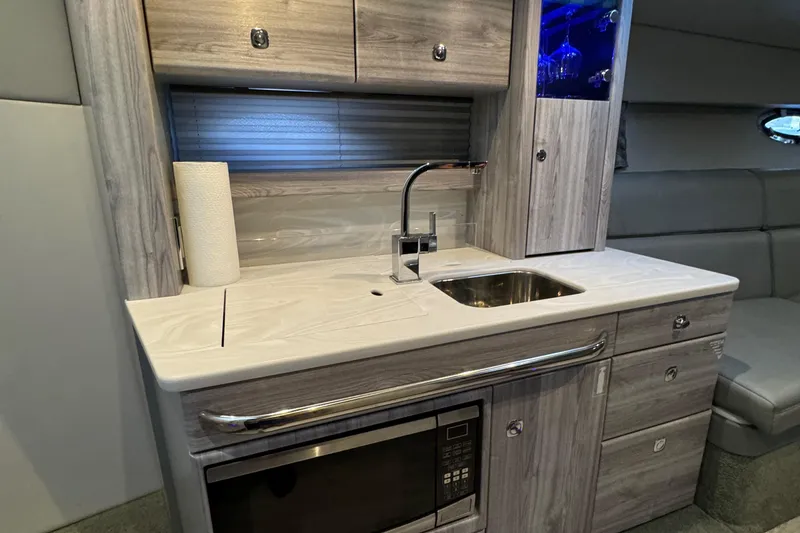 Slide: The Image of Modern kitchenette in 2020 Formula 370 SS boat with sink, microwave, and storage cabinets. - 32