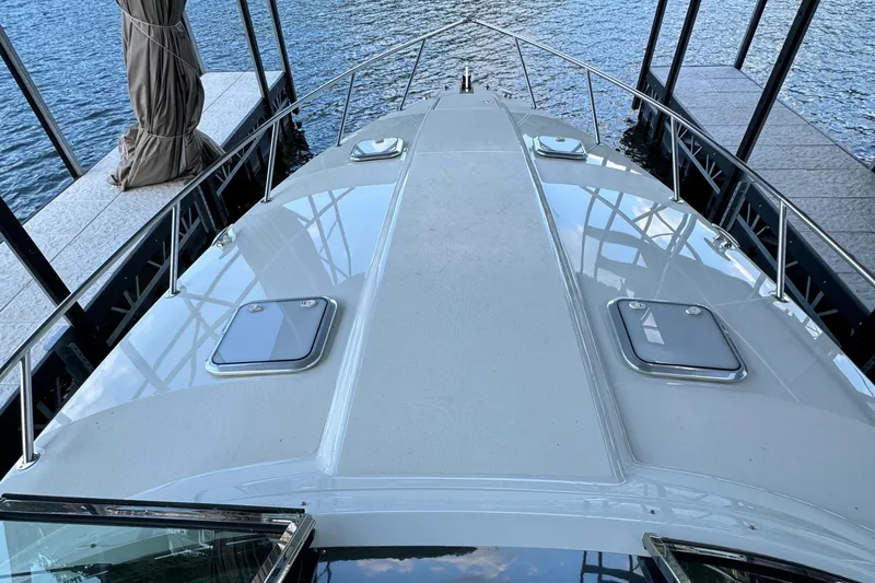 Slide: The Image of 2020 Formula 370 SS boat docked, showcasing sleek deck design and water reflections. - 38