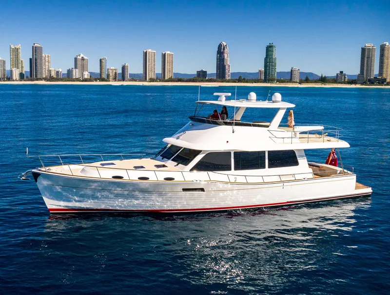 Slide: The Image of 2026 Grand Banks GB 60 yacht cruising near a city skyline. - 11