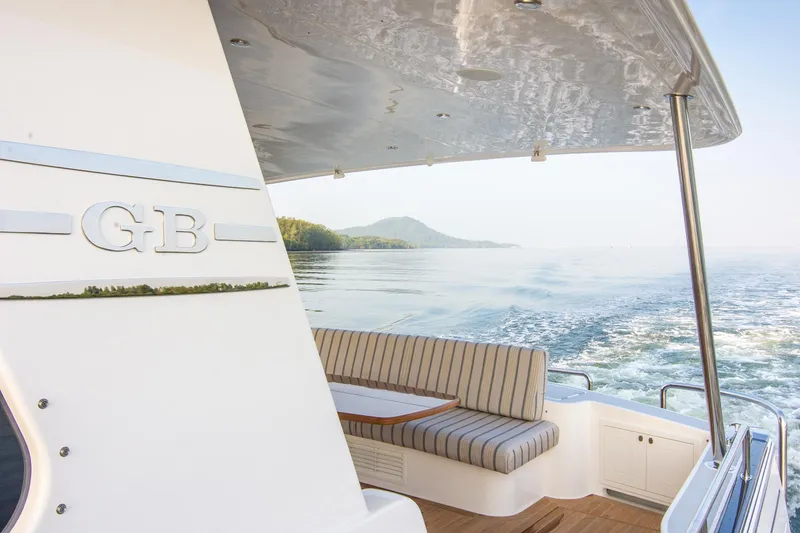 Slide: The Image of 2026 Grand Banks GB 60 yacht cruising with scenic ocean view. - 22
