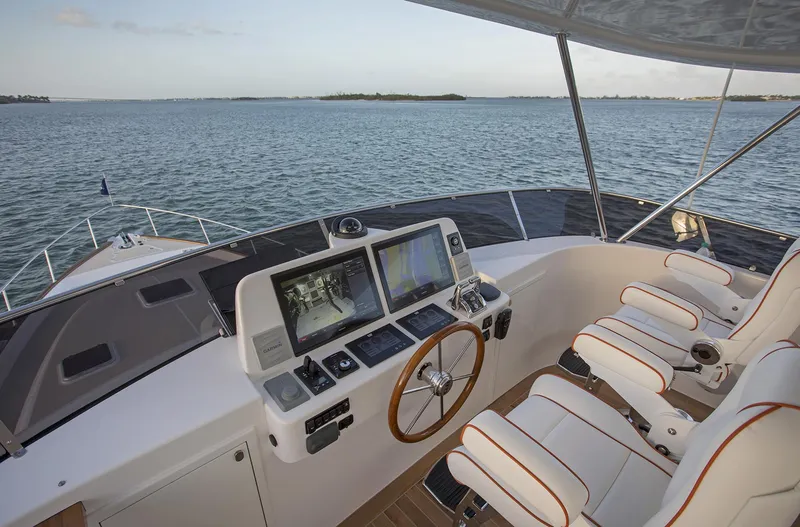Slide: The Image of Helm of 2026 Grand Banks GB 60 yacht with navigation screens and ocean view. - 4