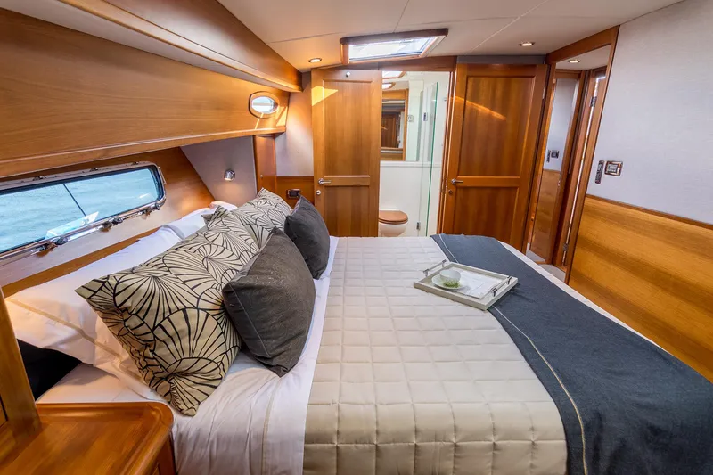 Slide: The Image of Luxurious bedroom interior of 2026 Grand Banks GB 60 yacht with elegant wood finish. - 7