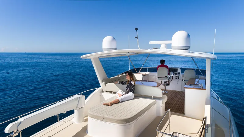Slide: The Image of 2026 Grand Banks GB 60 yacht cruising on open sea with passengers relaxing. - 24