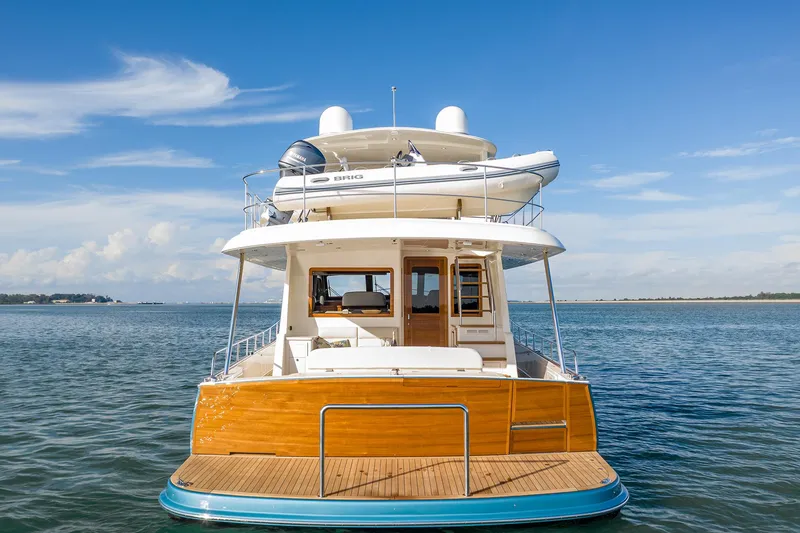 Slide: The Image of 2026 Grand Banks GB 60 yacht on calm sea, rear view, clear sky. - 19