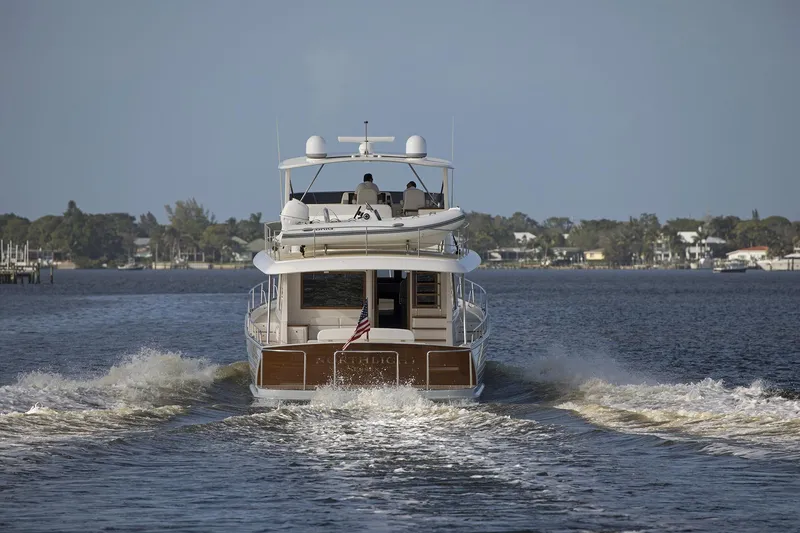 Slide: The Image of 2026 Grand Banks GB 60 yacht cruising on a calm waterway. - 2