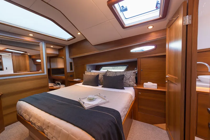 Slide: The Image of Luxurious cabin interior of 2026 Grand Banks GB 60 yacht, featuring elegant wood finishes. - 25