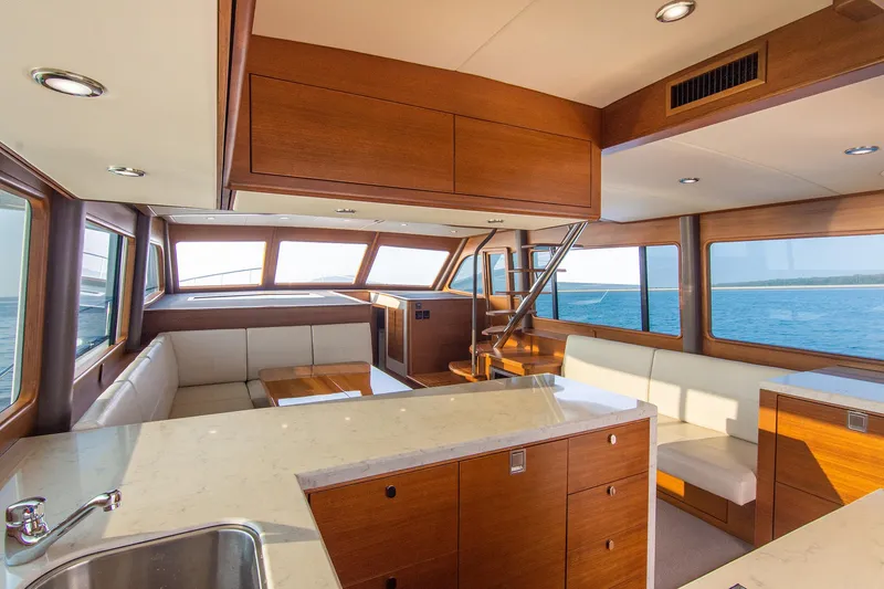 Slide: The Image of Luxurious interior of 2026 Grand Banks GB 60 yacht with modern wood finishes and ocean view. - 6