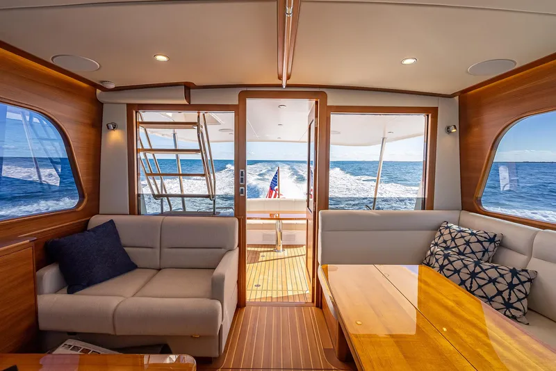 Slide: The Image of Interior of 2026 Grand Banks GB 54 yacht, featuring elegant seating and ocean view. - 18