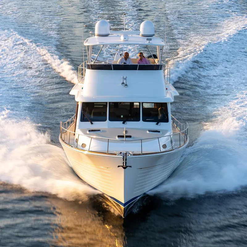 Slide: The Image of 2026 Grand Banks GB 54 yacht cruising on open water, front view. - 20