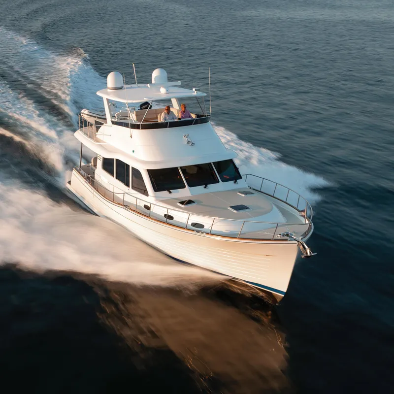 Slide: The Image of 2026 Grand Banks GB 54 yacht cruising on open water, showcasing sleek design and performance. - 24