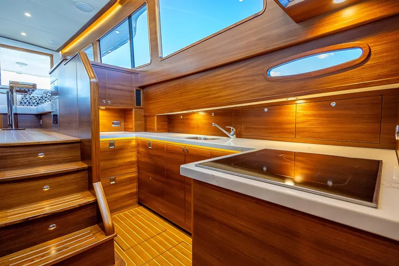 Slide: The Image of Luxurious kitchen interior of 2026 Grand Banks GB 54 yacht with wooden cabinetry. - 9