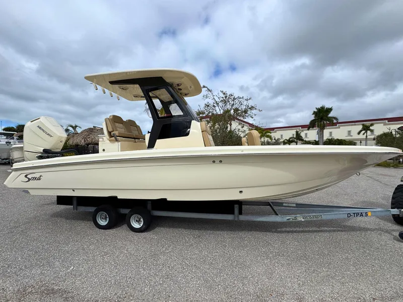 The Image of 2025 Scout 261 XSS boat on trailer, side view, cloudy sky background. - 0