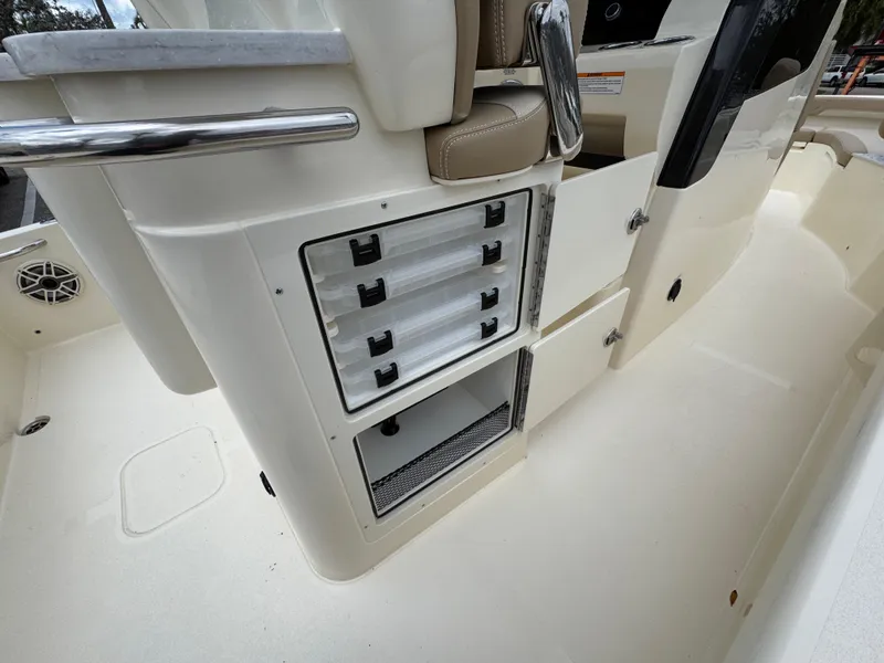 Slide: The Image of 2025 Scout 261 XSS boat interior with storage compartments and seating. - 20