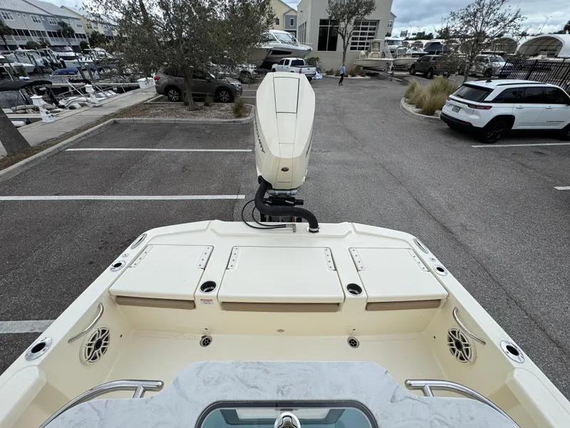 Slide: The Image of 2025 Scout 261 XSS boat in parking lot, rear view with motor and seating area. - 5