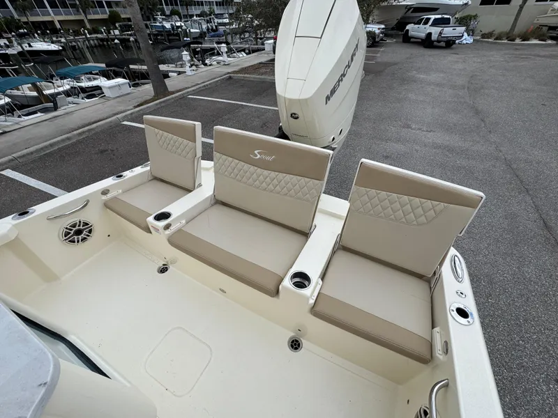 Slide: The Image of 2025 Scout 261 XSS boat seating area with beige cushioned seats and cup holders. - 6