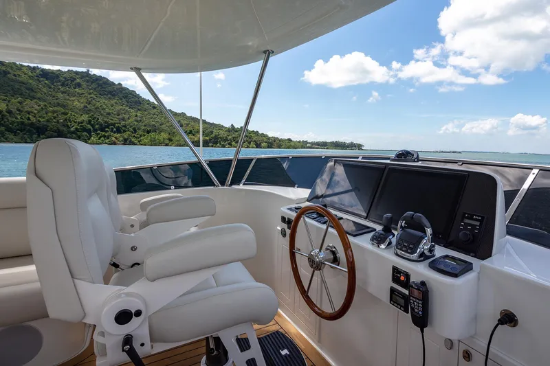 Slide: The Image of Luxury helm of 2026 Grand Banks GB 54 yacht with scenic ocean view. - 4