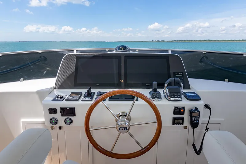 Slide: The Image of Helm of 2026 Grand Banks GB 54 yacht with dual screens and ocean view. - 7