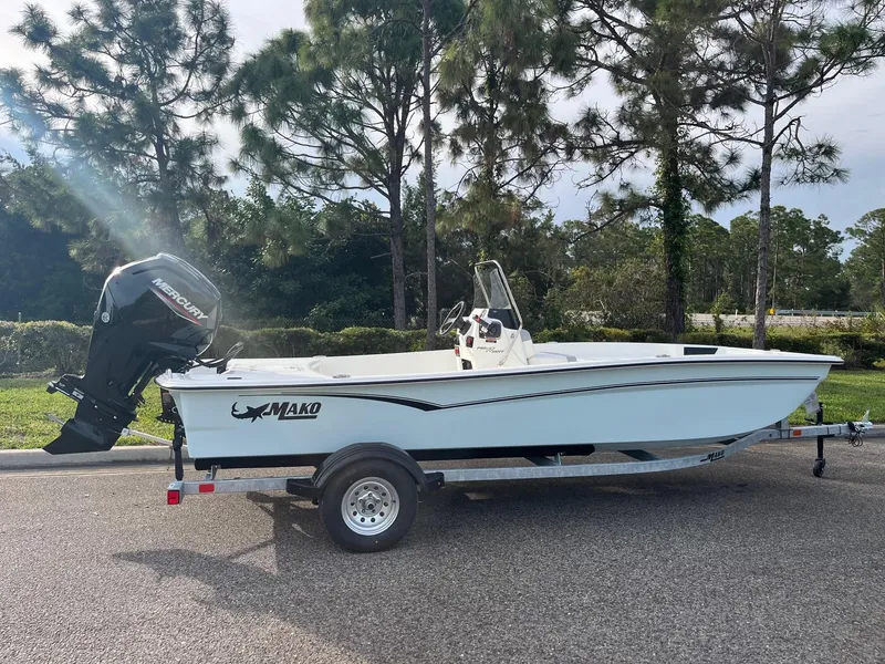 Slide: The Image of 2025 Mako Pro Skiff 17 CC boat on trailer, parked outdoors. - 1