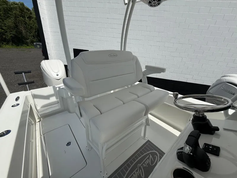 Slide: The Image of 2026 Pair Customs 28 boat interior with white seating and steering wheel. - 10
