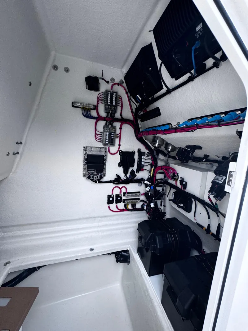 Slide: The Image of Electrical system inside a 2026 Pair Customs 28 boat, featuring wiring and components. - 16