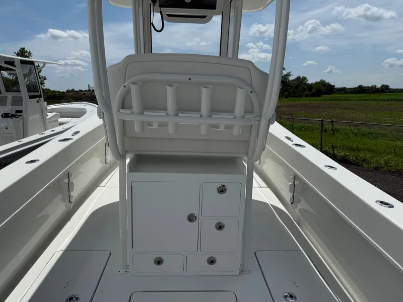 Slide: The Image of 2026 Pair Customs 28 boat interior with rod holders and storage compartments. - 7