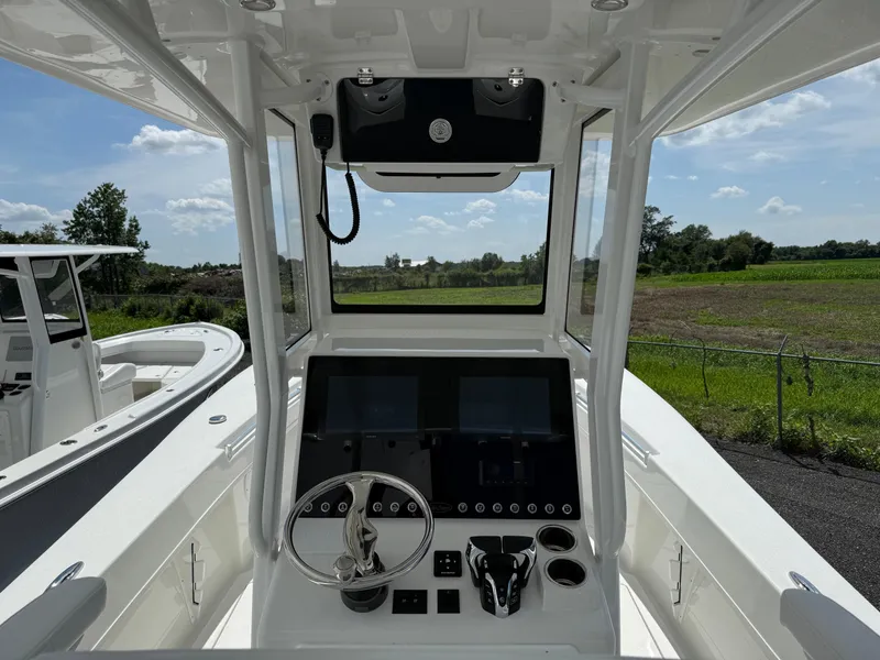 Slide: The Image of 2026 Pair Customs 28 boat cockpit with modern controls and steering wheel. - 9