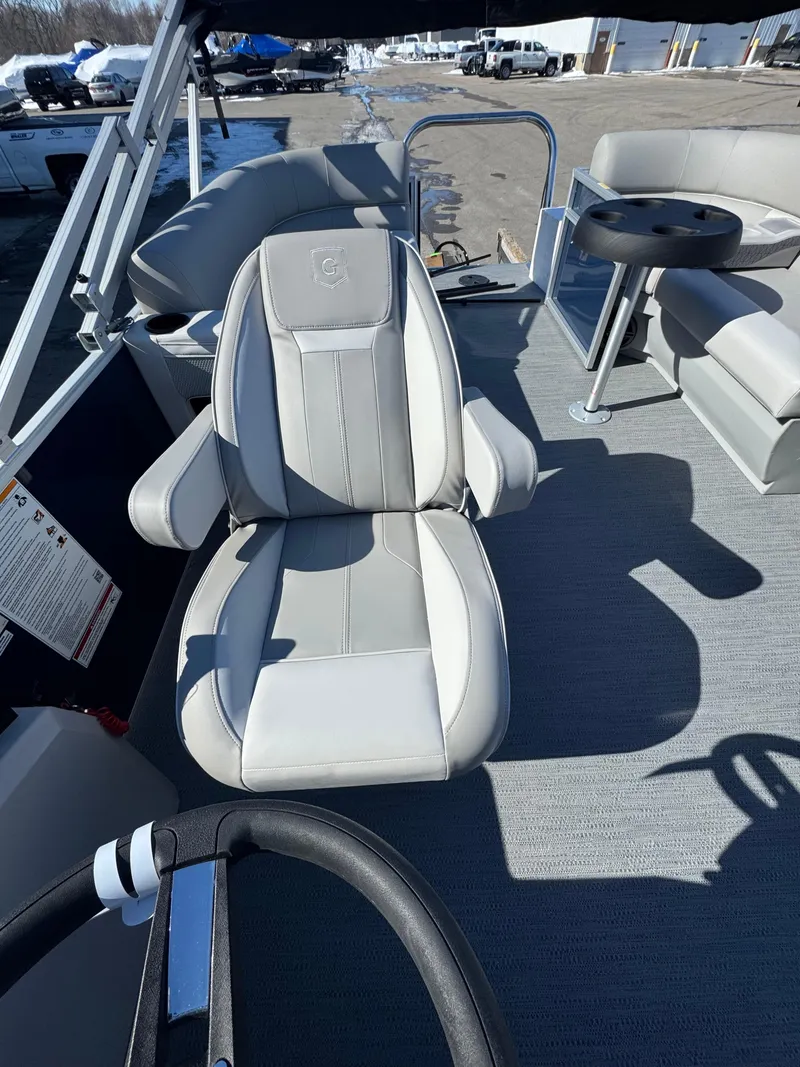 Slide: The Image of 2025 Xperience 2286 SBX boat interior with comfortable seating and steering wheel. - 10