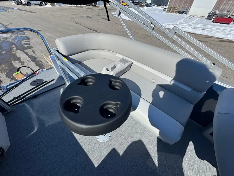Slide: The Image of 2025 Xperience 2286 SBX boat interior with gray seating and cup holder table. - 13